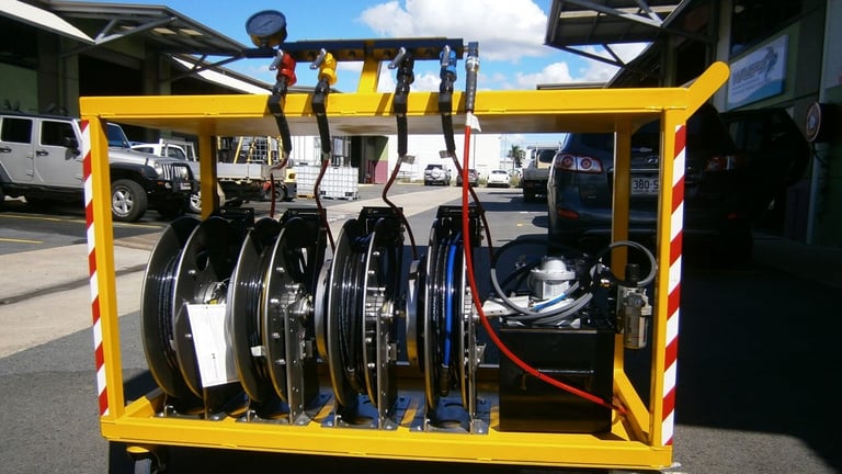 Yellow utility rack mounted on trailer displaying multiple bicycle wheels and tires organized vertically for transport and storage